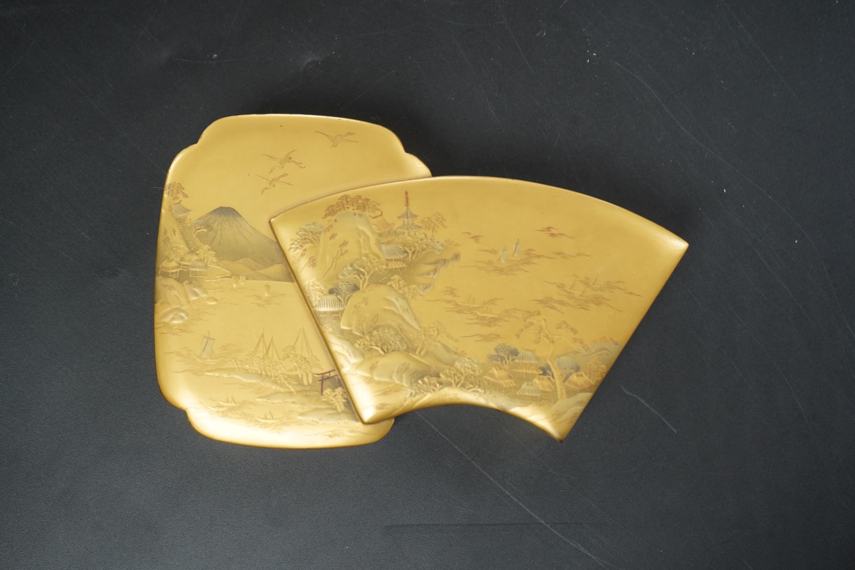 A Japanese gilt lacquer box depicting a mountainous landscape, 13.5cm wide